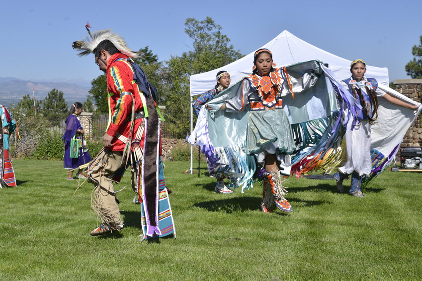 Native American dancers performing on the front yard of the Highlands Ranch Mansion for families as part of Pioneer Days. Following the performance, they answered questions from the families.